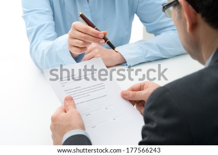 Man signs purchase agreement for a  house