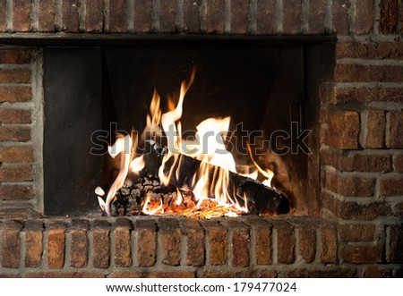 Fire in fireplace. Closeup of firewood burning in fire