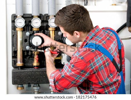 Technician servicing the gas boiler for hot water and heating