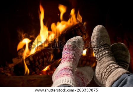 Couple relaxing at the fireplace on winter evening
