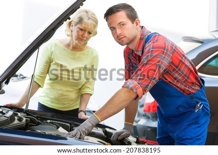 Auto mechanic and female customer in auto repair shop