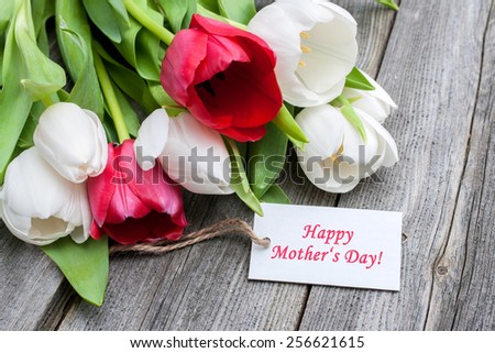 Tulips with tag and text for mother\'s day on wooden background
