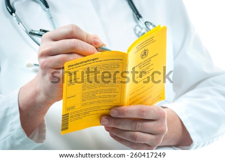 Doctor is filling out an international certificate of the vaccination