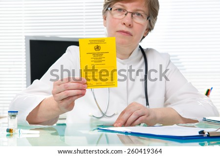Doctor showing an international certificate of the vaccination