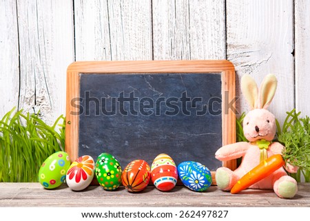 Easter decoration with sugar rabbits, eggs and message board