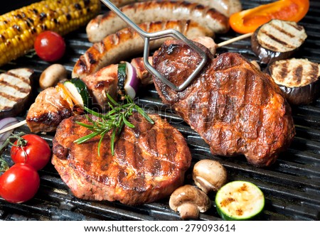 Assorted delicious grilled meat with vegetable over the coals on a barbecue