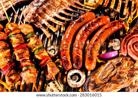 Assorted delicious grilled meat with vegetable over the coals on a barbecue