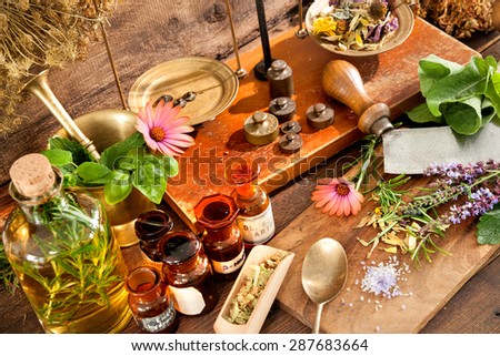 Ancient natural medicine, herbal, vials and scale on wooden background