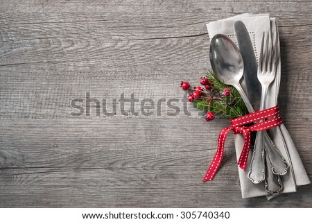 Christmas table place setting with christmas pine branches,ribbon and bow. Christmas holidays background