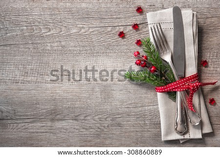 Christmas table place setting with christmas pine branches,ribbon and bow. Christmas holidays background