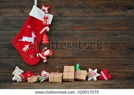 Christmas decoration stocking and toys hanging over rustic wooden background