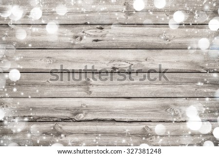 Christmas frame on wooden background with snow and lights