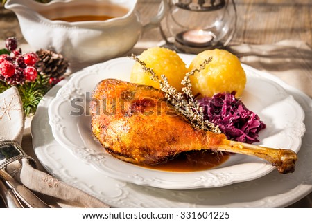 Crusty Christmas goose leg with braised red cabbage and dumplings