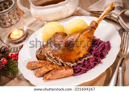 Crusty Christmas goose leg with braised red cabbage and dumplings