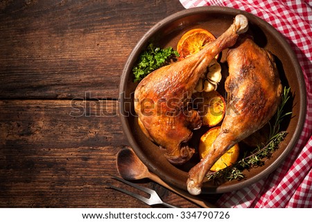 Roasted goose legs with oranges and spices. Cooking at Christmas time