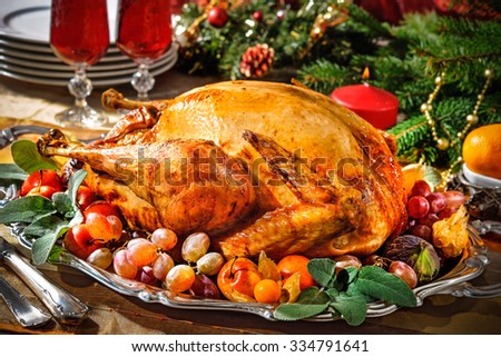 Roasted turkey on holiday table with candles