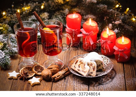 Christmas mulled wine on table with burning advent candles and christmas decorations