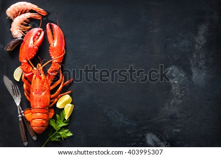 Shellfish plate of crustacean seafood with fresh lobster, mussels, shrimps as an ocean gourmet dinner background