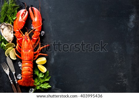 Shellfish plate of crustacean seafood with fresh lobster, mussels, shrimps, oysters as an ocean gourmet dinner background