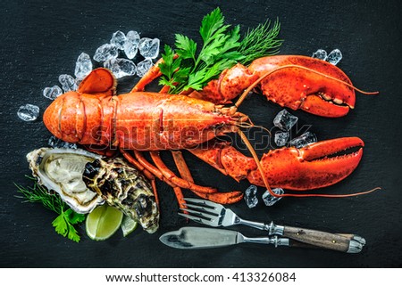Shellfish plate of crustacean seafood with fresh lobster, mussels, oysters as an ocean gourmet dinner background