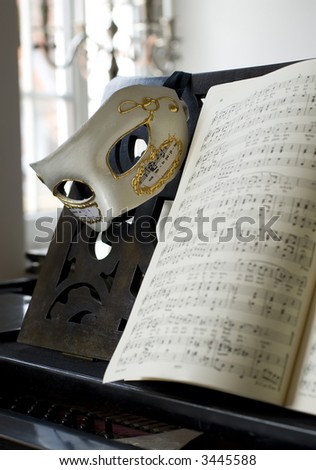 Grand Piano, lyrics book and venice mask, focus on mask