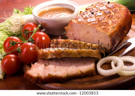 Close-up of a roast tenderloin pork served with vegetables