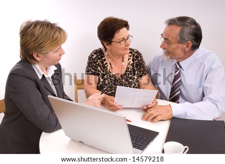 Mature couple talking to financial planner