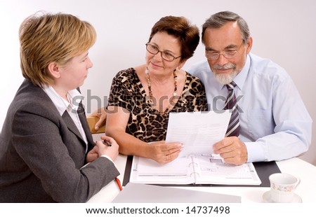 Mature couple talking to financial planner