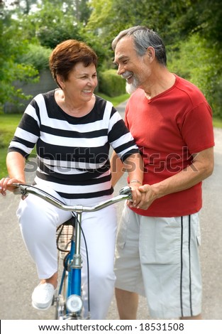 An attractive senior couple bicycling