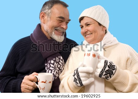 happy elderly couple drinking hot tea