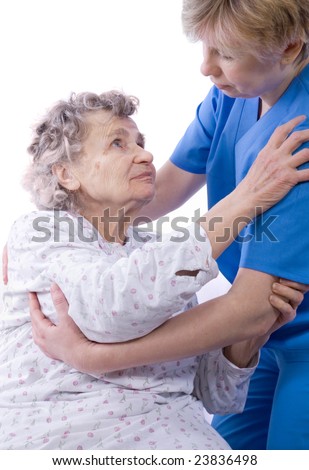 nurse helps the senior woman get up