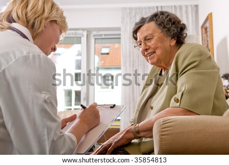 Senior woman is visited home by her doctor or caregiver at home