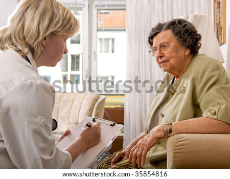 Senior woman is visited home by her doctor or caregiver at home