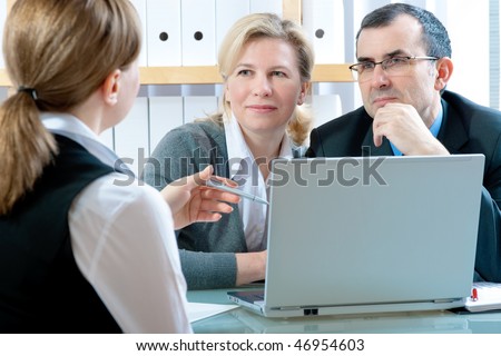 stock photo : mid-adult couple meeting with financial planner