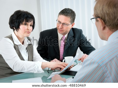 woman and her lawyer in conversation with husband during divorce process