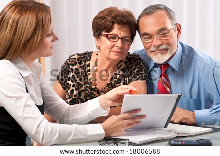 Senior couple meeting with agent or advisor Senior couple meeting with agent or advisor