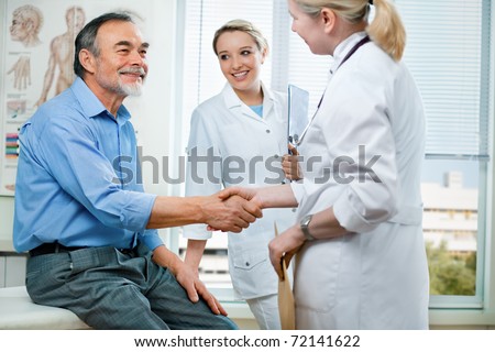 doctor shakes hands with a senior patient