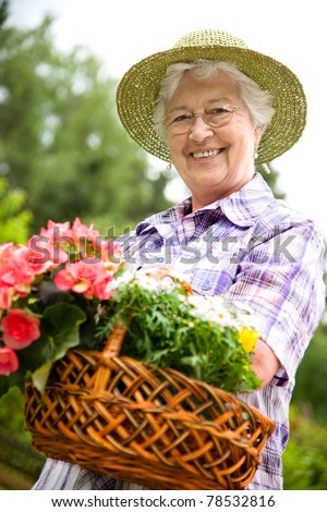 Portrait of pretty senior woman gardening