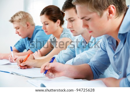 group of students studying together in classroom