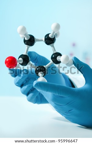 hands of scientist with a molecular structure at the lab