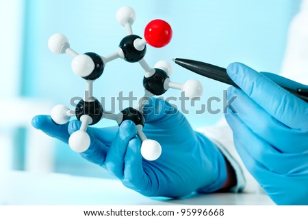 hands of scientist with a molecular structure at the lab