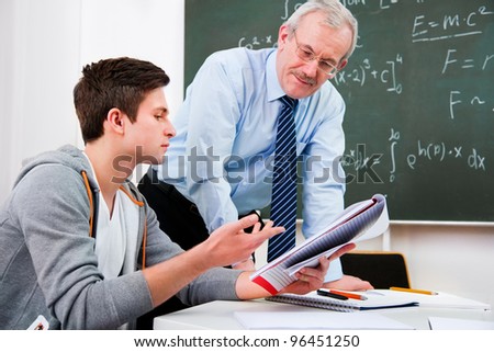 teacher with a group of high school students  in classroom