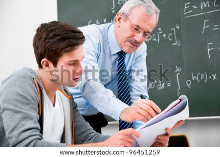 teacher with a group of high school students  in classroom