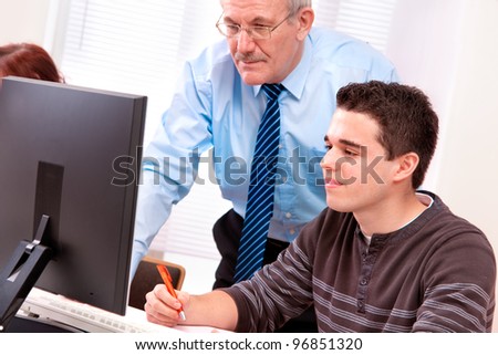 Students with a teacher in computer classroom