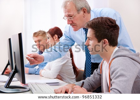 Students with a teacher in computer classroom