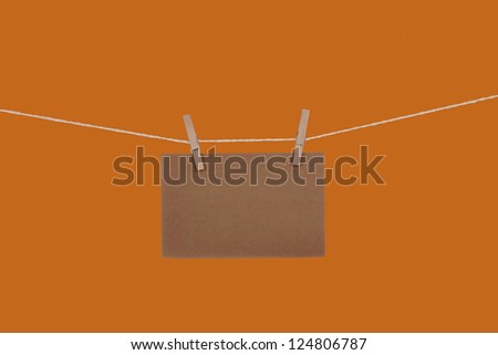 Blank paper cards hanging on clothespins