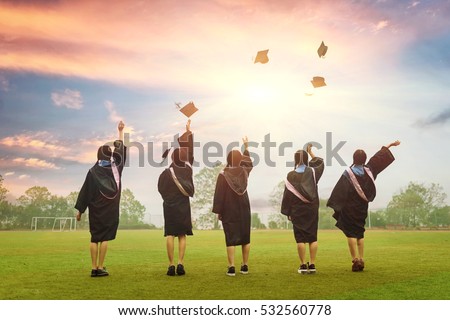 graduates throwing graduation hats in the air.