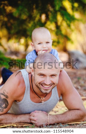 Beautiful portrait of a father and son smiling - outdoors
