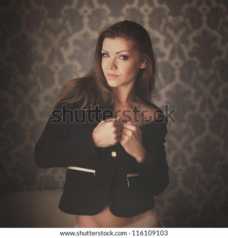 Portrait of happy young woman posing against grunge background