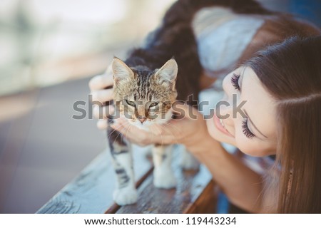 young woman with cat outdoors